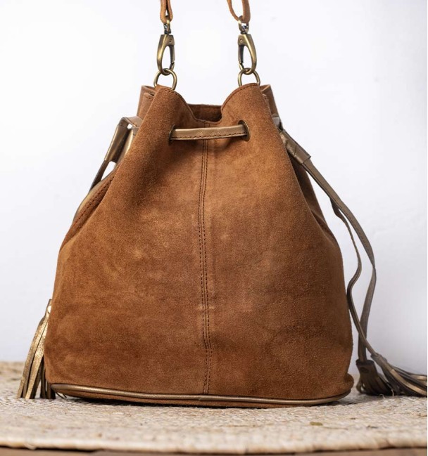 Pistachio colt leather bag with front pocket and green colt leather with lilac dots. Bronze piece and stone in the centre