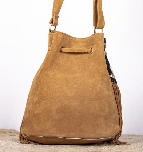 Bag type bag in leather and front pocket in black and brown colt leather. Bronze piece and stone in the centre