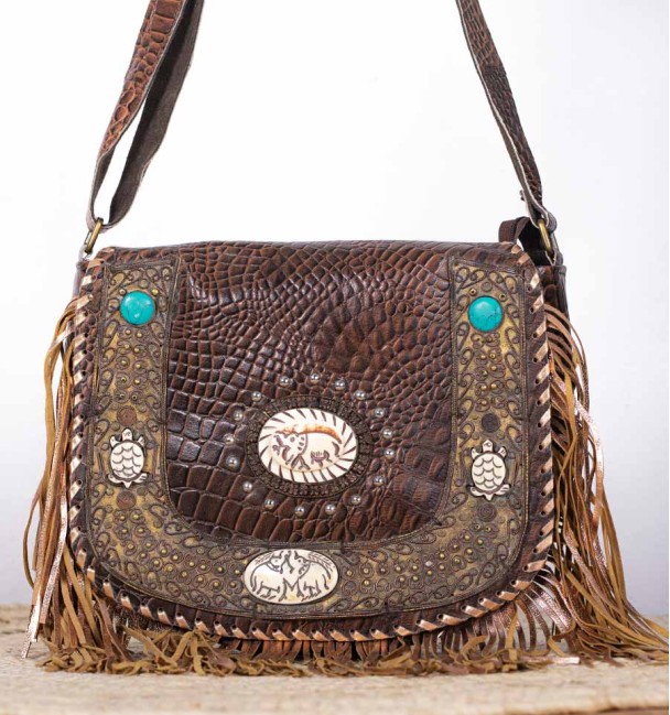 boho leather bag with brass and carved bone trimmings, close-up