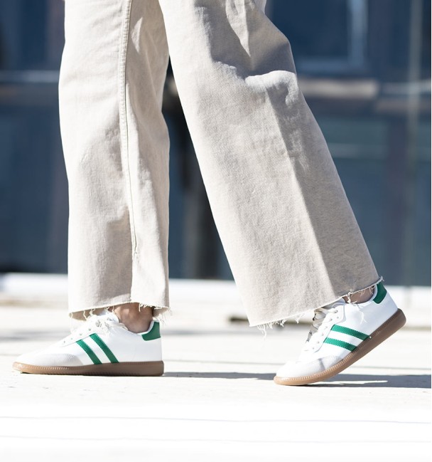 Trainers combined in green and white lines. Brown rubber sole