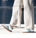 Trainers combined in green and white lines. Brown rubber sole