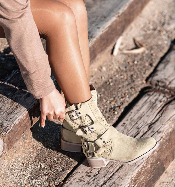 beige coloured cowboy boots with buckles and die-cut mid-calf. Animal free