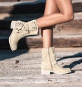 beige coloured cowboy boots with buckles and die-cut mid-calf. Animal free