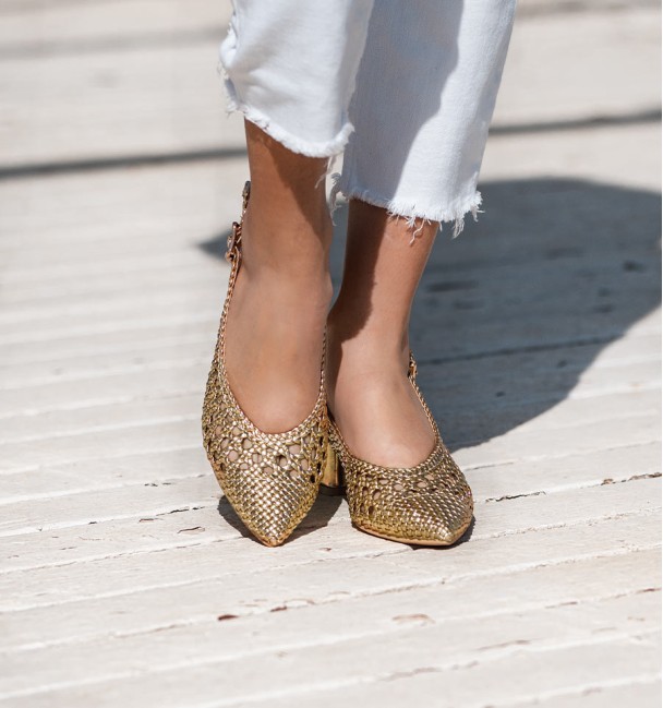 Golden ankle strap shoes with wide heel and buckle at the ankle. Braided instep