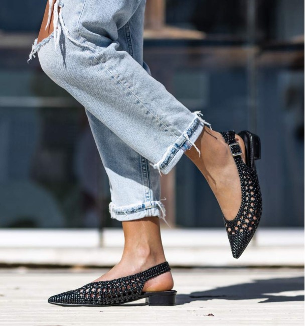 Black ankle boot with wide heel and buckle at the ankle. Braided instep