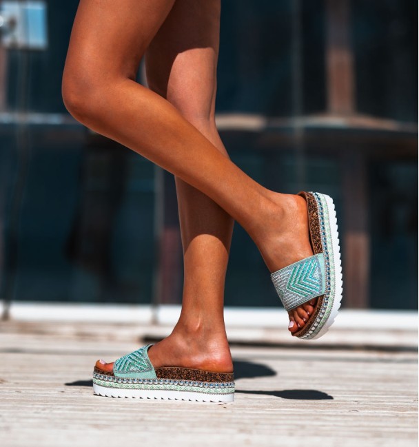 white rubber and cork platform sandals. studs border and beaded vamp in shades of green.