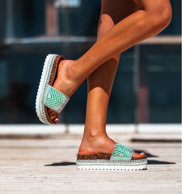 white rubber and cork platform sandals. studs border and beaded vamp in shades of green.