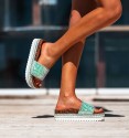 white rubber and cork platform sandals. studs border and beaded vamp in shades of green.