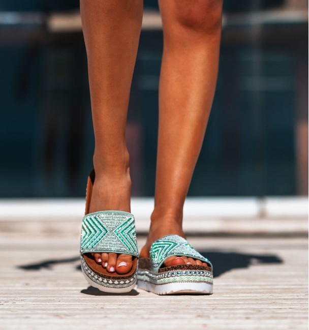 white rubber and cork platform sandals. studs border and beaded vamp in shades of green.