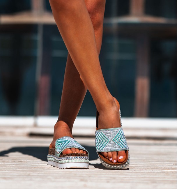 white rubber and cork platform sandals. studs border and beaded vamp in shades of green.
