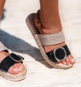 Sandals with a light platform in esparto grass and white rubber. Jute and textile straps on the instep. Golden buckle.