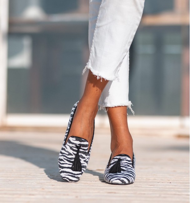 zapatos tacón bajo ancho blancos y negros, print de cebra, ribete y borlas en negro. Material textil imitación pelo natual.