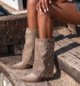 women's mid-calf boots, with flap and heel. Buckle on the top, studs and shiny studs on the back and bottom of the boot.