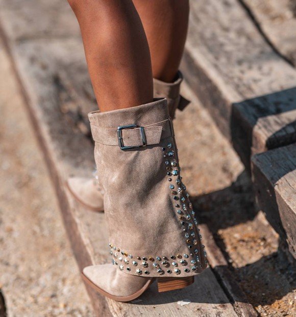 women's mid-calf boots, with flap and heel. Buckle on the top, studs and shiny studs on the back and bottom of the boot. 2