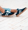 navy blue trainers with white stripes and laces, rubber sole. Trendy sneakers