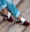 Wine color trainers with white tongue and two lateral white stripes. Trendy women's trainers. Animal free