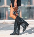 women's black boots, with flap and heel. Buckle and chain studs