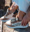 Women's trainers in combined materials with glitter stripes on the side and animal print heel. brown and beige colours.