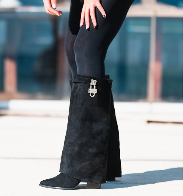 Black women's tall boots with flap and heel. Strap and padlock on the top