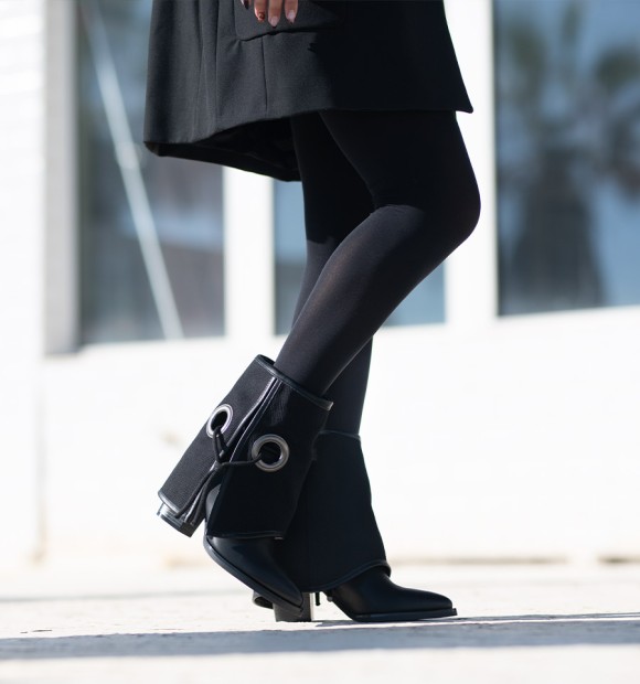 Black low top boots in black eyelet gaiter with black lacing. Wide heel and pointed toe finish. 2