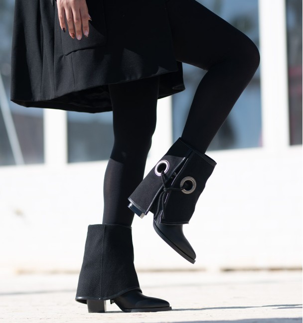 Black low top boots in black eyelet gaiter with black lacing. Wide heel and pointed toe finish.