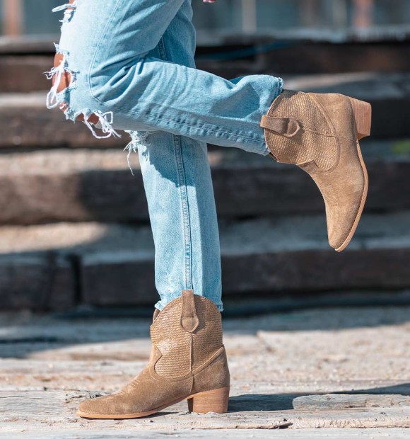 Beige cowboy style boots with woven shaft and medium heel. 2