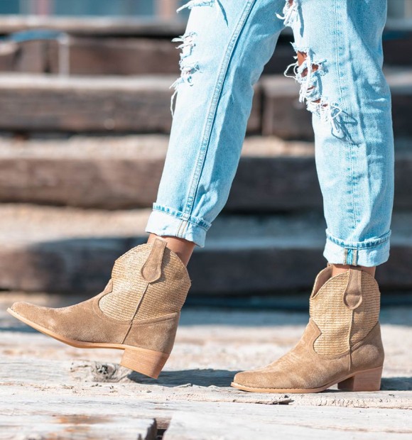 Beige cowboy style boots with woven shaft and medium heel.