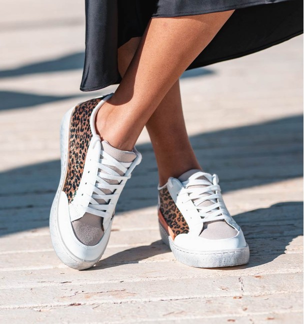 white sneakers with leopard print and side phrase detail. Vegan leather