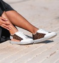 white sneakers with leopard print and side phrase detail. Vegan leather