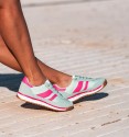 Sneakers in turquoise with fuchsia stripes and white and fuchsia combined sole.