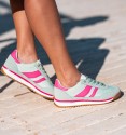 Sneakers in turquoise with fuchsia stripes and white and fuchsia combined sole.