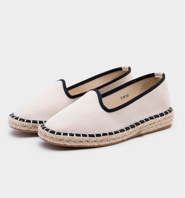 Beige and black espadrilles with yute soil.