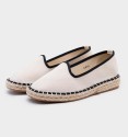 Beige and black espadrilles with yute soil.