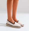Beige and black espadrilles with yute soil.