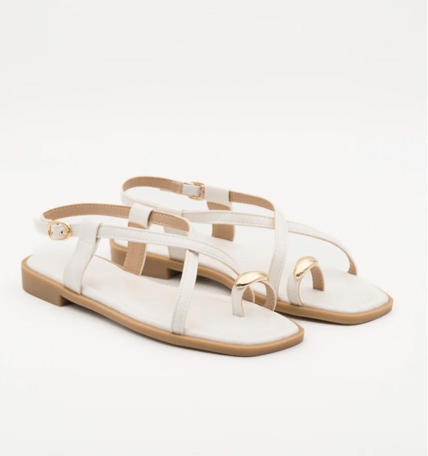 white leather sandals with gold detail on the toe