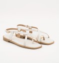 white leather sandals with gold detail on the toe