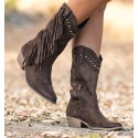 Brown cowboy boots with fringes and studs